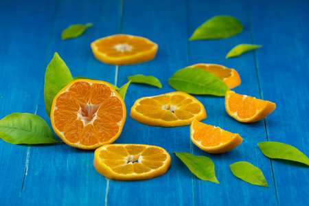 orange and tangerine fruit on a blue wooden background
