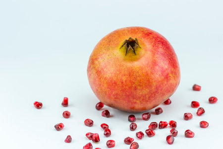 Ripe pomegranate fruit with seeds on white background.の写真素材