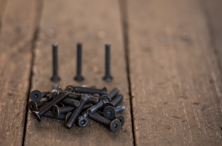 Screws on a wooden table. selective focus. Shallow depth of field.の写真素材