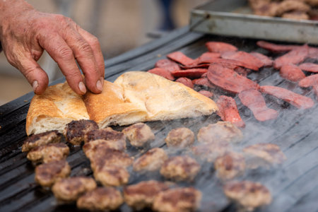 Chef cooking meatballs on the grill at a street food festival