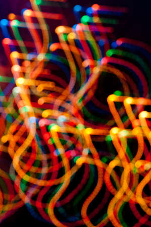 Coloured freezeelight dots and stripes on dark  blue background