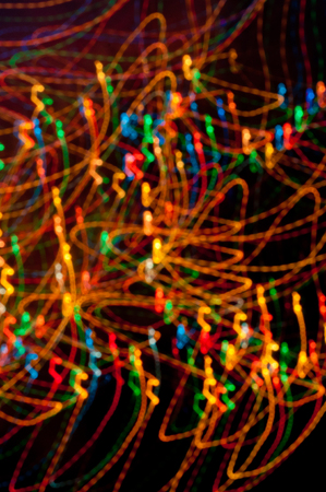 Coloured freezeelight dots and stripes on dark backgroundの写真素材