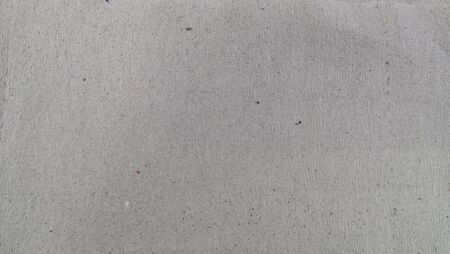 Gray grungy paper sheet with heterogeneous sprinkles, textureの写真素材