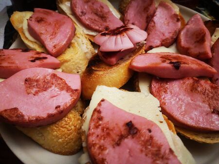 Fried sausage sandwiches. Appetizing sandwiches. Sandwiches on a glass plate.の写真素材