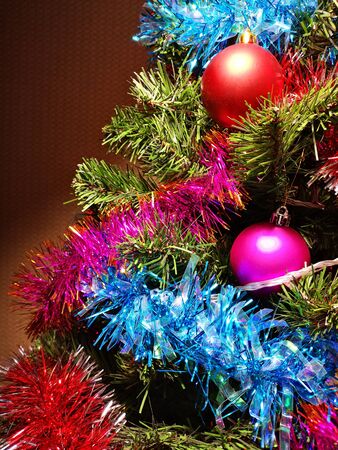 Christmas tree decorated with glittering toys shines beautifully with colorful lightsの写真素材