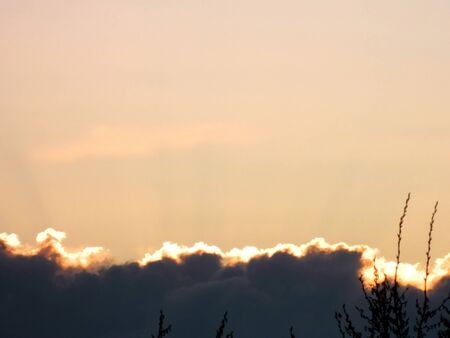 A beautiful cloud illuminated by the sunlight at dawnの写真素材