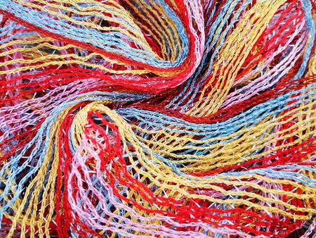 Beautiful bright background of juicy red, pink and yellow threadsの写真素材