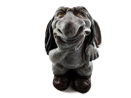 The gray troll looks forward with thoughtful thinking, pointing his finger down. Isolate.の写真素材