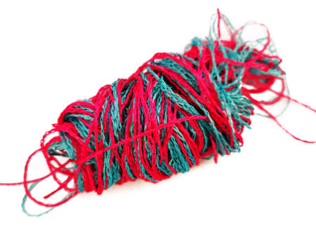 Beautiful bright juicy pink and blue threads are frazzled in a tangle and lie on a white background, isolate.の写真素材
