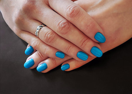 Manicure blue varnish on long nailsの写真素材