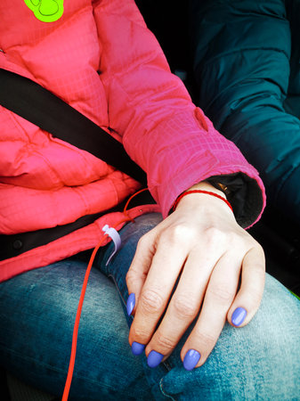 Manicure with purple varnish on the hand of a white young girlの写真素材