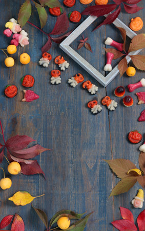 Frame of fall leaves, candy for Halloween. Holidays and food. Background for design. High quality...