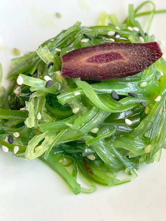 Chukka seaweed salad with sesame seeds on plate. Traditional Japanese food. Top view. . High quality...