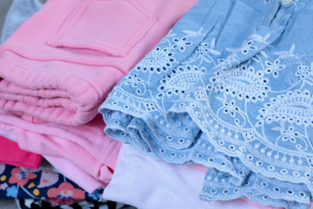 Baby blue vintage style embroidered dress and pink pants. Cleaning and recycling. Ecology and recycling. High quality photoの写真素材