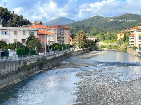 Mountain river, traditional buildings in town of Italy. Tourism and vacation, Liguria. Sunny day and nature. Background for design. High quality photoの写真素材