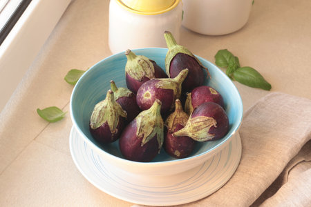 Mini eggplants in bowl. Vegetables and healthy eating. Ecologically clean products from the garden. High quality photoの写真素材
