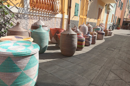 Traditional woven African baskets on street of old town in Italy. Private business, market and sales. Objects for kitchen, home, handmade. High quality photoの写真素材