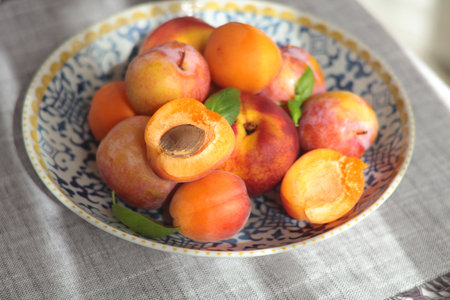 Fruits on porcelain plate with blue pattern. Food and vitamins, healthy eating. Seasonal food. High...