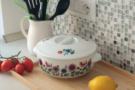 Retro-style ceramic tureen with lid floral patterns. Food in kitchen. Interior design and style....