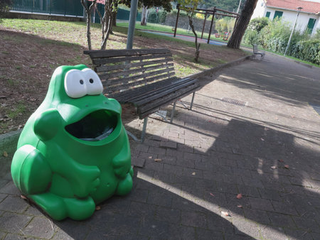 Frog-shaped trash bin on playground. Garbage collection and ecology. Urban development. High quality photoの写真素材