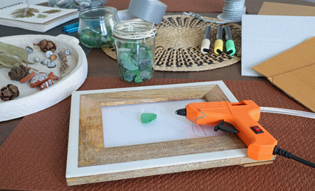 Sea glass in frame. Making art from natural materials. Glue gun and driftwood for picture. Hobbies...