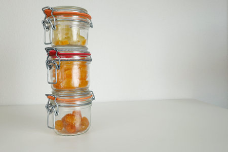 Preparing candied citrus fruits for jars. Sweets and traditional food in Italy. Kumquats, orange peels, and citron. Seasonal, high-quality European farm products. High quality photoの写真素材
