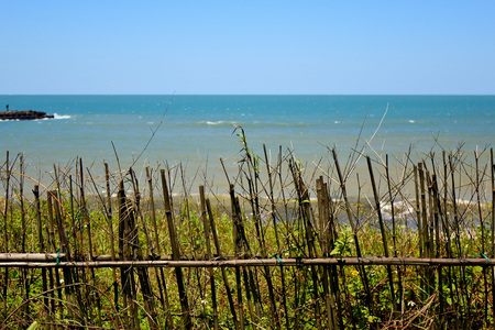 Seascape of bamboo fence with skyの写真素材