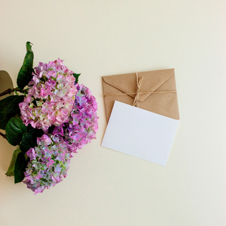 Half of the envelope of eco paper with yellow flowers on black background. Flat lay. There's room for text or design.の写真素材