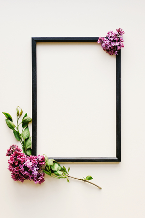 Flowers composition. Frame on white background. Lilac flowers and a white satin ribbon bow. Valentine's day, mother's Day, women's day, spring concept. Flat position, top view, copy spaceの写真素材
