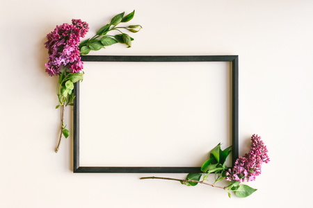 Flowers composition. Frame on white background. Lilac flowers and a white satin ribbon bow. Valentine's day, mother's Day, women's day, spring concept. Flat position, top view, copy spaceの写真素材