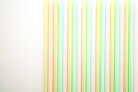 Collection of colourful plastic drinking straws on a white background.の写真素材