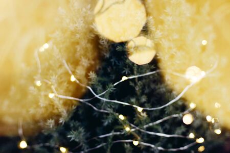 A beautiful image of a bokeh from New Year's garlands. In gold colors. Defocused glitter lighting...