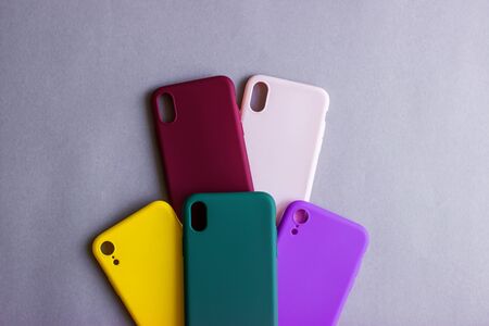 Set of colored silicone cases for the smartphone on the grey background.の写真素材