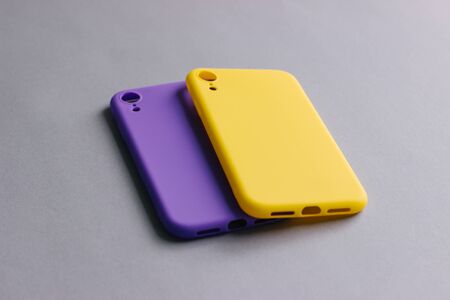 Colorful silicone cases for your smartphone. Bright yellow and purple silicone cases for smartphone. Flat lay.の写真素材