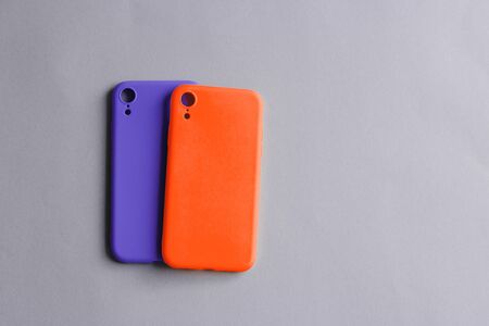 Colorful silicone cases for your smartphone. Bright yellow and purple silicone cases for smartphone. Flat lay.の写真素材