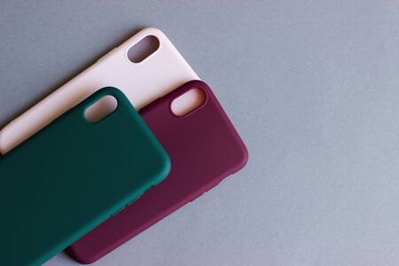 Set of colored silicone cases for the smartphone on the grey background.の写真素材