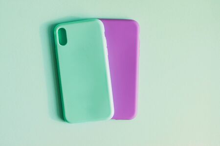 Colorful silicone cases for your smartphone on light background. Mint and purple cases for the smartphone. Protective silicone cases for phone. Selective focus.の写真素材