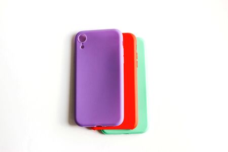 Colorful silicone cases for your smartphone on light background. Mint, red and purple cases for the smartphone. Protective silicone cases for phone. Selective focus.の写真素材