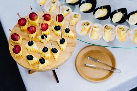 Cheese with grapes on skewers. Delicious appetizer at the Banquet. Cheese canape.の写真素材