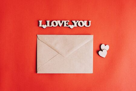 Kraft the envelope for the letter. The letter is a love letter. Valentine's Day. February 14. Wooden figures in the shape of hearts and the inscription I love you.の写真素材