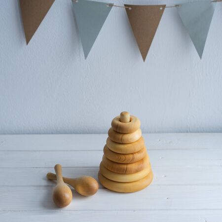Childrens pyramid and maracas are made of natural wood. Toys for children, made by hand from natural wood. Wooden shavings.の写真素材