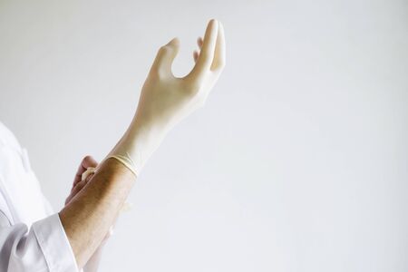 The doctor is on the front line. The doctor or nurse wears gloves. The doctors hands are wearing...