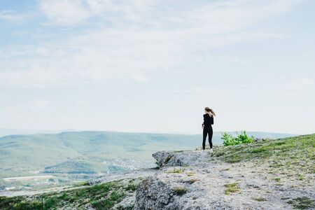 A girl runs in the mountains. Outdoor sports.