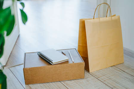 Shopping online. Delivery to the door. Contactless delivery of goods. Buy sitting at home. Package and boxes delivered by courier. Stay home.の写真素材