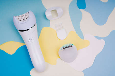 Electric epilator for removing hair on a woman's body. Epilator with multiple attachments.