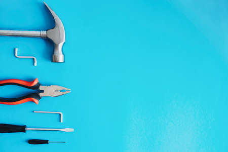 Tools for repair on a blue background. Hammer, pliers and screwdrivers. Happy Fathers Day.