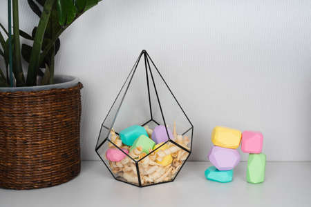 Children's wooden constructors in a glass florarium. Colored cubes of various shapes.の写真素材
