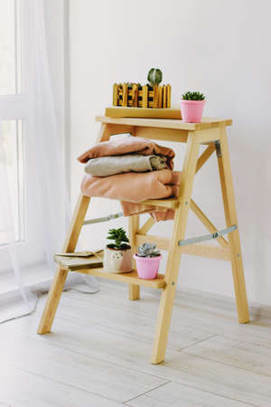 Several warm sweaters on a wooden shelf