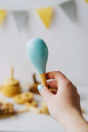 Childrens rattle made of natural wood. The rattle is painted blue. Childrens toys made of natural...