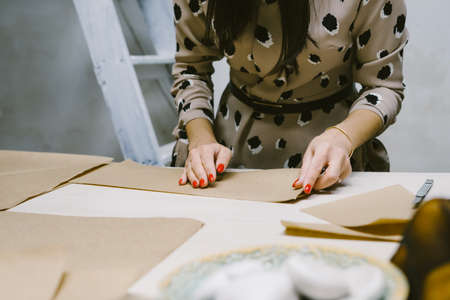 Creating hand made christmas ornaments. DIY personalized xmas decoration. Snowflake or three-dimensional star made of kraft paper.の写真素材